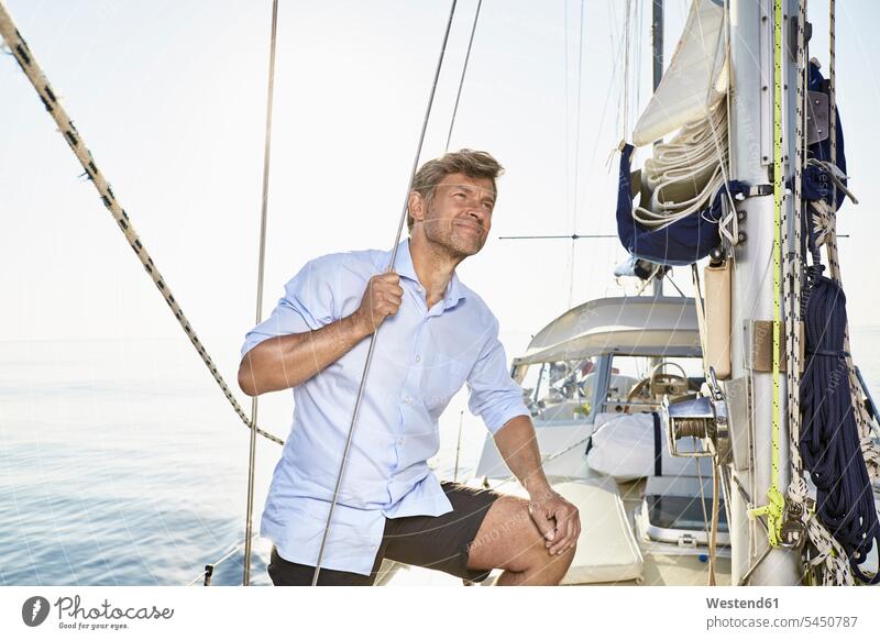 Mature man on his sailing boat men males boat sports Adults grown-ups grownups adult people persons human being humans human beings standing portrait portraits