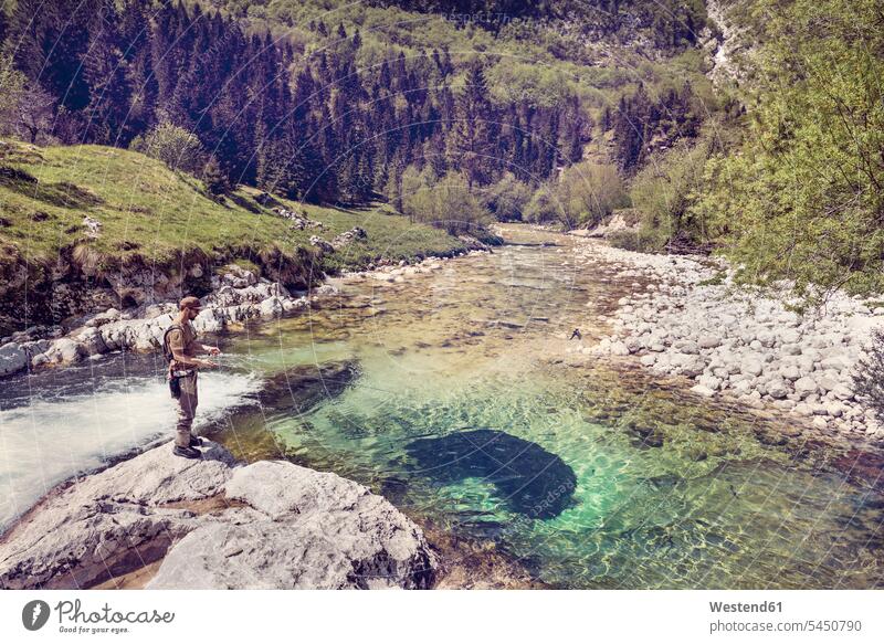 Slovenia, man fly fishing in Soca river standing angler anglers angling River Rivers men males fly-fishing water waters body of water Adults grown-ups grownups