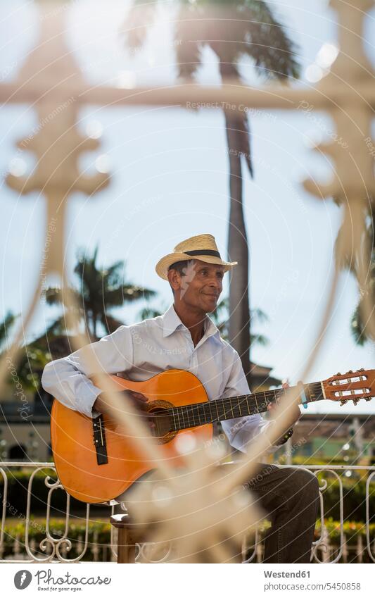 Cuba, Trinidad, man playing guitar on the street street musician street musicians men male adults males guitarist guitarists guitars Adults grown-ups grownups