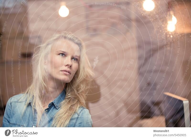 Portrait of blond woman in an office looking out of the window windows portrait portraits females women Adults grown-ups grownups adult people persons