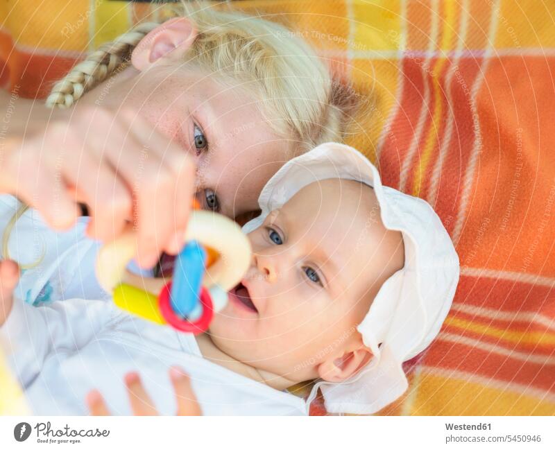 Girl playing with baby girl on blanket portrait portraits females girls baby girls child children kid kids people persons human being humans human beings babies