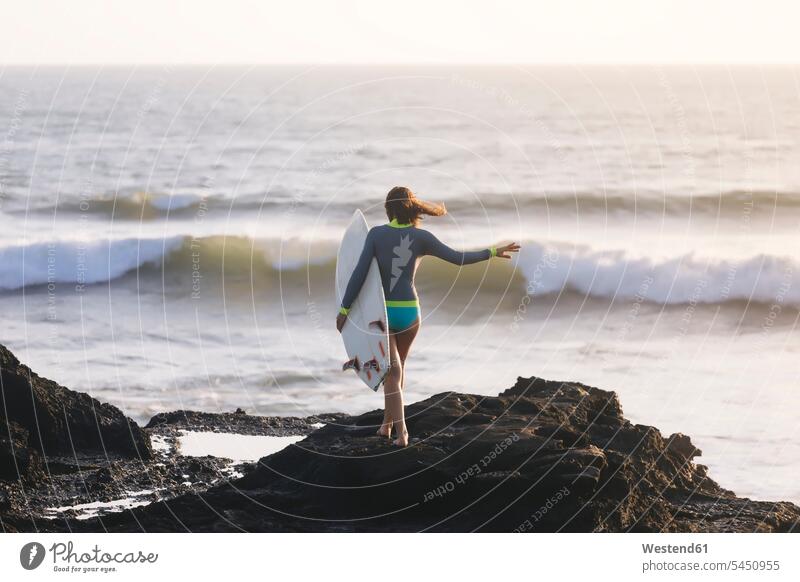 Indonesia, Bali, young woman with surfboard walking going surfer female surfer surfers female surfers leisure free time leisure time carrying females women