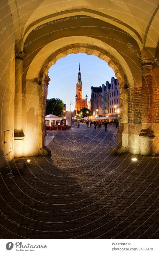 Poland, Gdansk, view through Green Gate to Long Market at evening twilight illumination lighting green gate townhall town hall city hall arch pavement paving