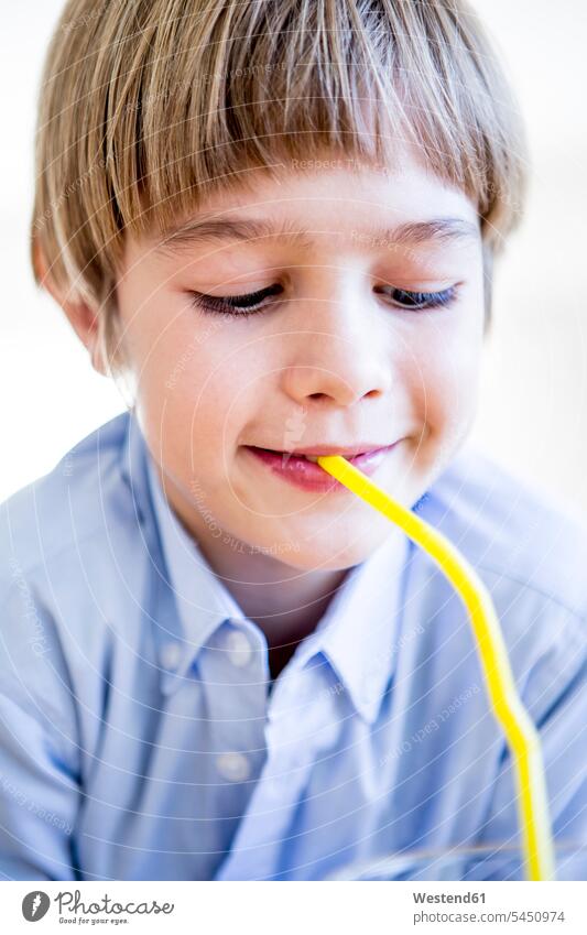 Boy drinking from straw straws drinking straw drinking straws boy boys males smiling smile child children kid kids people persons human being humans