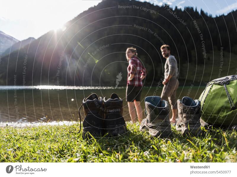 Austria, Tyrol, hiking shoes and couple refreshing in mountain lake Refreshment mountain lakes mountains twosomes partnership couples hike hiker wanderers