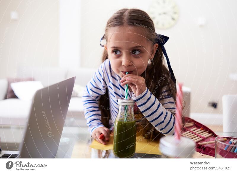 Portrait of little girl drinking green smoothie females girls portrait portraits child children kid kids people persons human being humans human beings