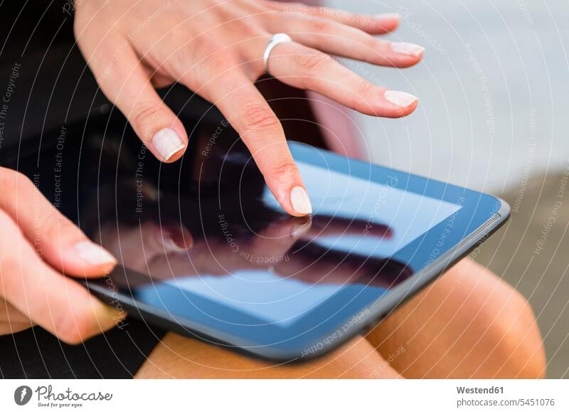 Businesswoman using tablet, close-up businesswoman businesswomen business woman business women index finger forefingers trigger fingers index fingers digitizer