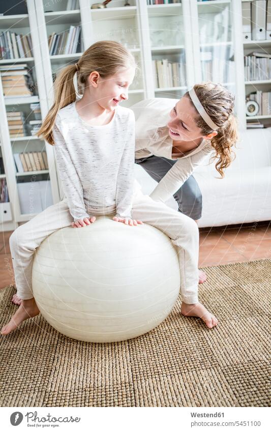 Mother and daughter with fitness ball at home Fitness Ball Fitness Balls Balance Ball exercise ball Stability Ball Gym Ball Swiss ball daughters sportive