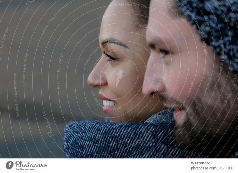 Portrait of smiling young couple close together outdoors closeness propinquity smile portrait portraits twosomes partnership couples people persons human being