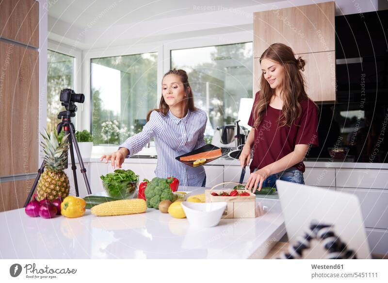 Bloggers cooking in modern kitchen cameras smile human human being human beings humans person persons adult grown-up grown-ups grownup grownups female females