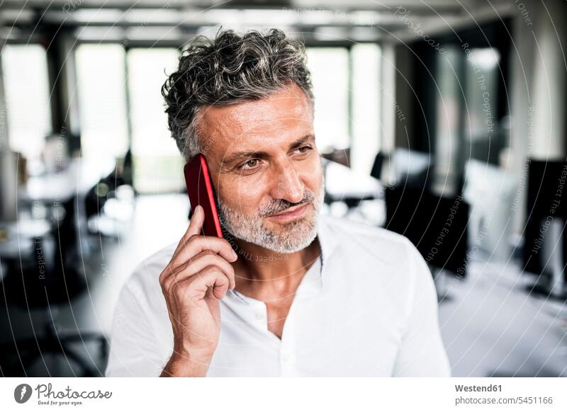 Portrait of mature businessman on cell phone in office mobile phone mobiles mobile phones Cellphone cell phones Businessman Business man Businessmen