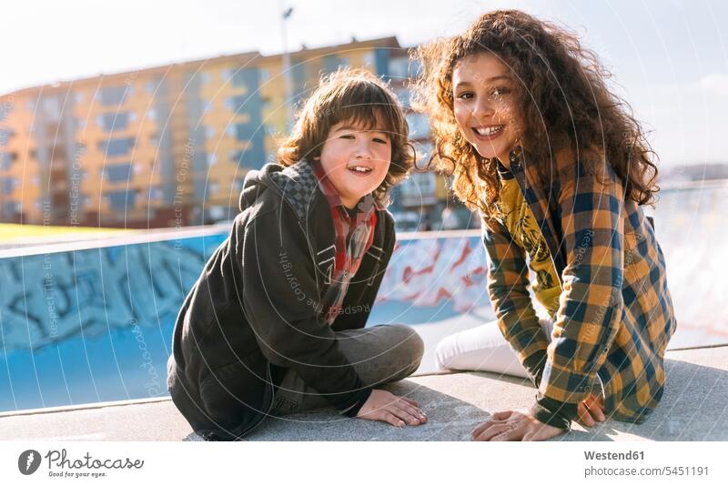 Portrait of two children sitting on a wall portrait portraits friends friendship skatepark Skateboard Park skate park walls kid kids smiling smile Seated parks