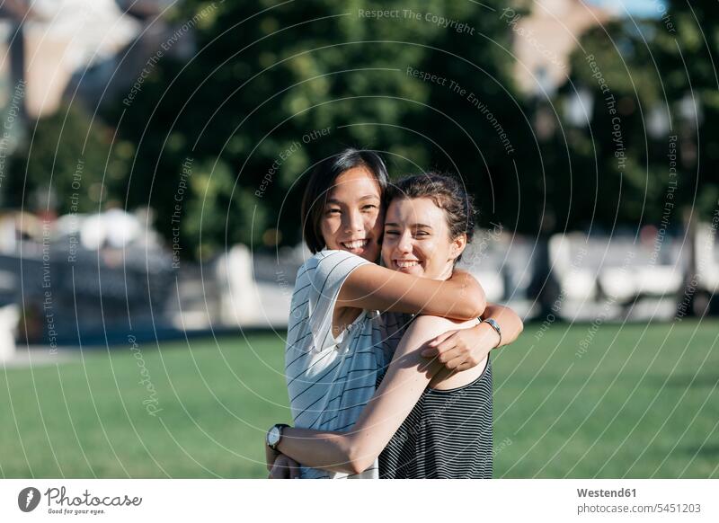 Portrait of two best friends hugging each other in the park embracing embrace Embracement female friends portrait portraits mate friendship City Park