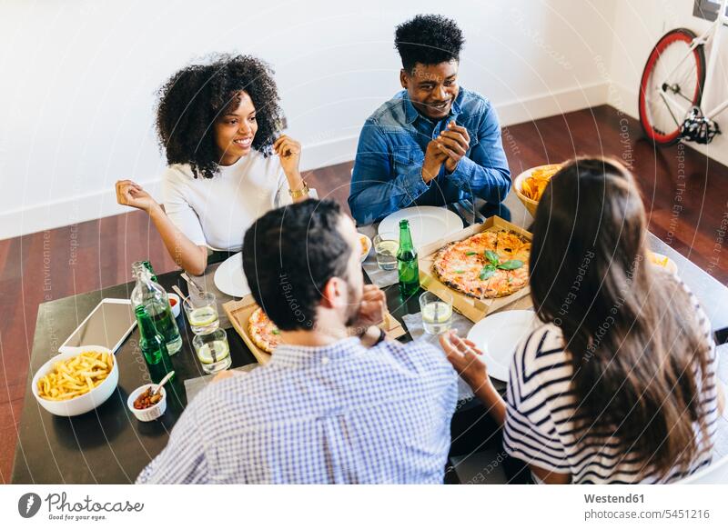 Group of friends having a pizza at home Table Tables Pizza Pizzas eating Food foods food and drink Nutrition Alimentation Food and Drinks friendship Beer Beers