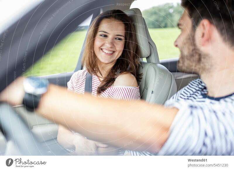 Couple driving in car drive steering couple twosomes partnership couples car driving motoring belted fastened automobile Auto cars motorcars Automobiles