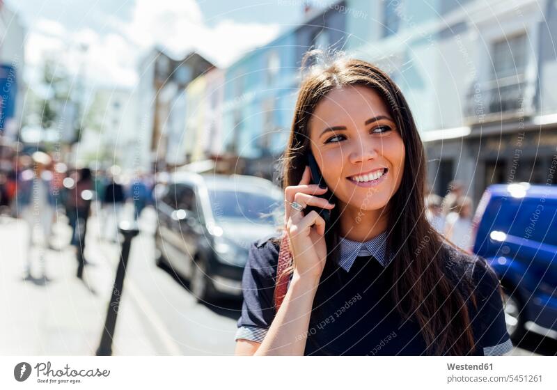 UK, London, Portobello Road, portrait of smiling woman on the phone females women portraits call telephoning On The Telephone calling Adults grown-ups grownups