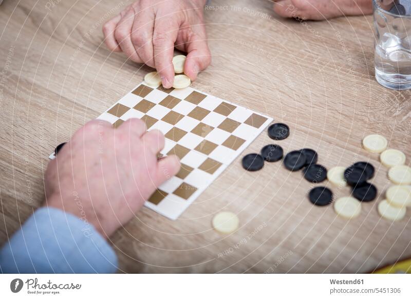 Two people playing chequers board game board-games boardgame board games games evening hand human hand hands human hands Checkers draughts Checkers Game