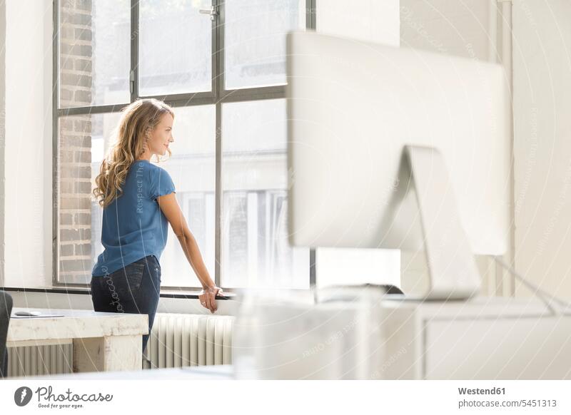 Casual businesswoman in office looking out of window pensive thoughtful Reflective contemplative entrepreneur entrepreneurs businesswomen business woman
