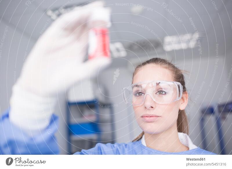 Scientist in lab examining sample swatch Swatches Samples scientist looking view seeing viewing checking examine laboratory female scientists science sciences