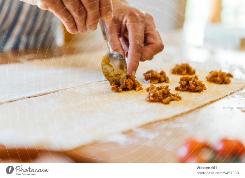 Woman's hands putting ravioli stuffing on dough human hand human hands Ravioli people persons human being humans human beings cooking preparing Food Preparation
