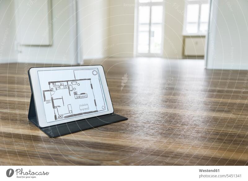 Tablet with floor plan on wooden floor flat flats apartment apartments floor plans ground plan ground plans tablet digitizer Tablet Computer Tablet PC