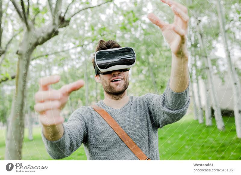 Man wearing virtual reality glasses in nature using his hands Virtual Reality Glasses VR glasses Virtual-Reality Glasses virtual reality headset vr headset