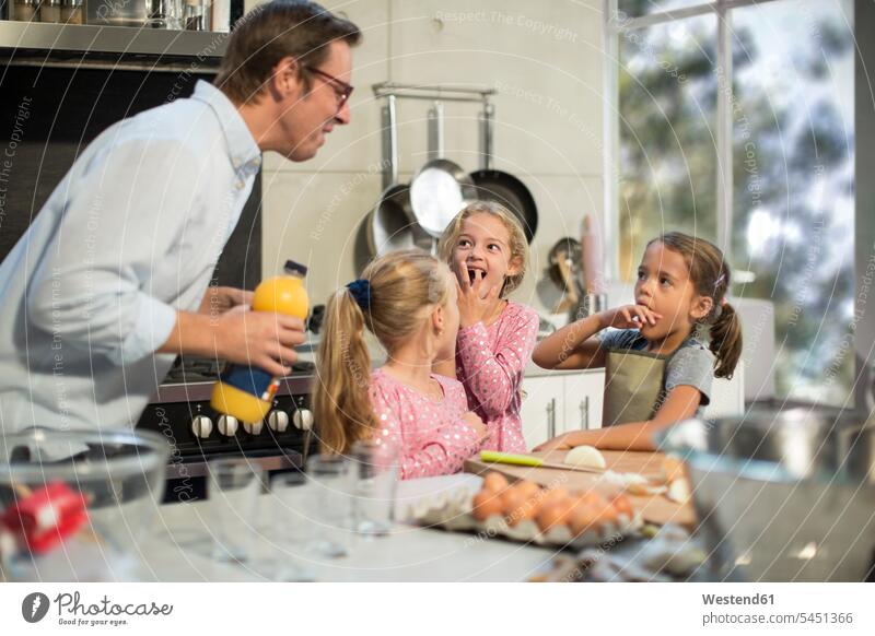 Family cooking together in kitchen Egg Eggs daughter daughters baking bake learning family families father pa fathers daddy dads papa helping Fruit Juice