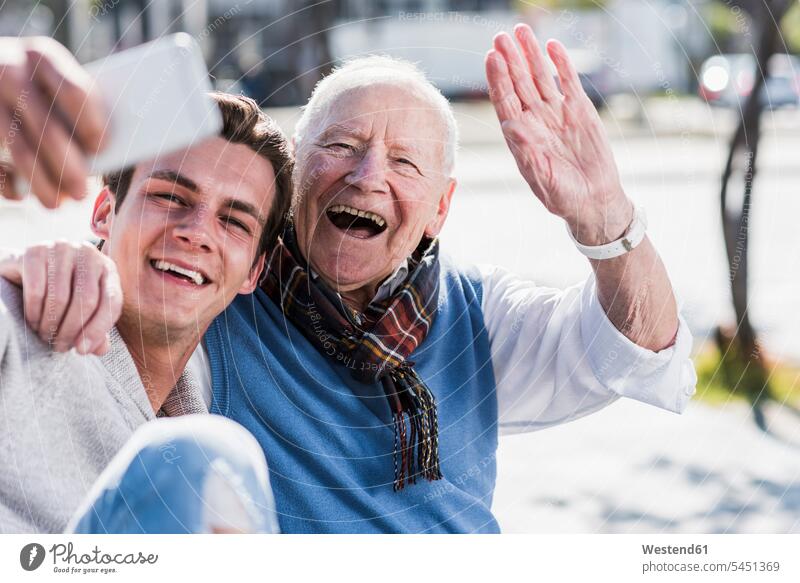 Happy senior man and adult grandson taking a selfie smiling smile happiness happy Fun having fun funny grandfather grandpas granddads grandfathers Selfie