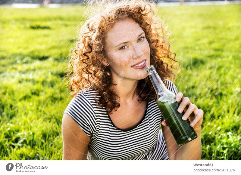 Portrait of redheaded young woman enjoying beverage females women Drink beverages Drinks Beverage portrait portraits Adults grown-ups grownups adult people