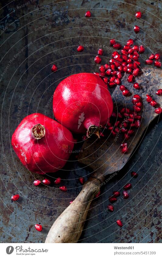 Two whole pomegranates, pomegranate seed and cleaver food and drink Nutrition Alimentation Food and Drinks fruit Freshness fresh Pomegranate Pomegranates