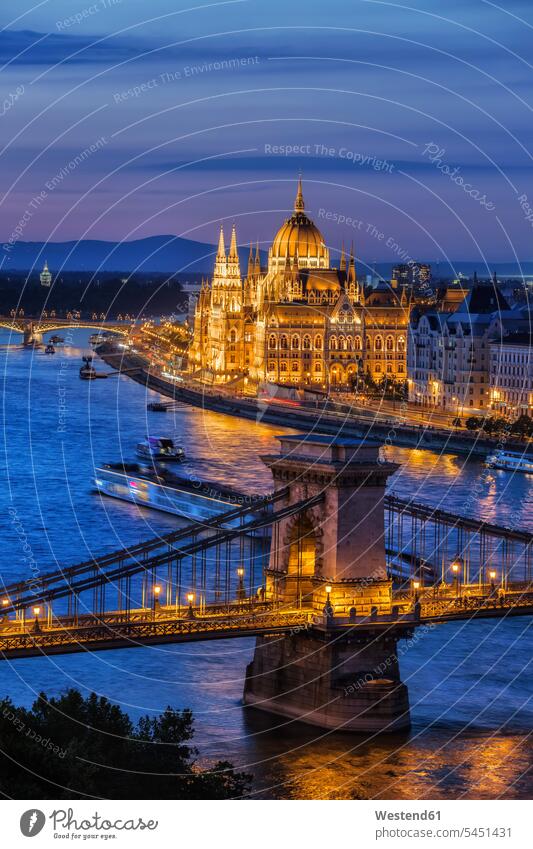 Hungary, Budapest, tranquil evening in the city with lit up Hungarian Parliament and Chain Bridge on Danube River ship evening light copy space Rivers