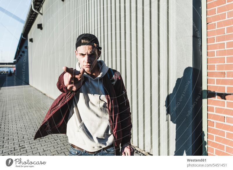 Portrait of aggressive young man gesturing serious earnest Seriousness austere portrait portraits men males Adults grown-ups grownups adult people persons