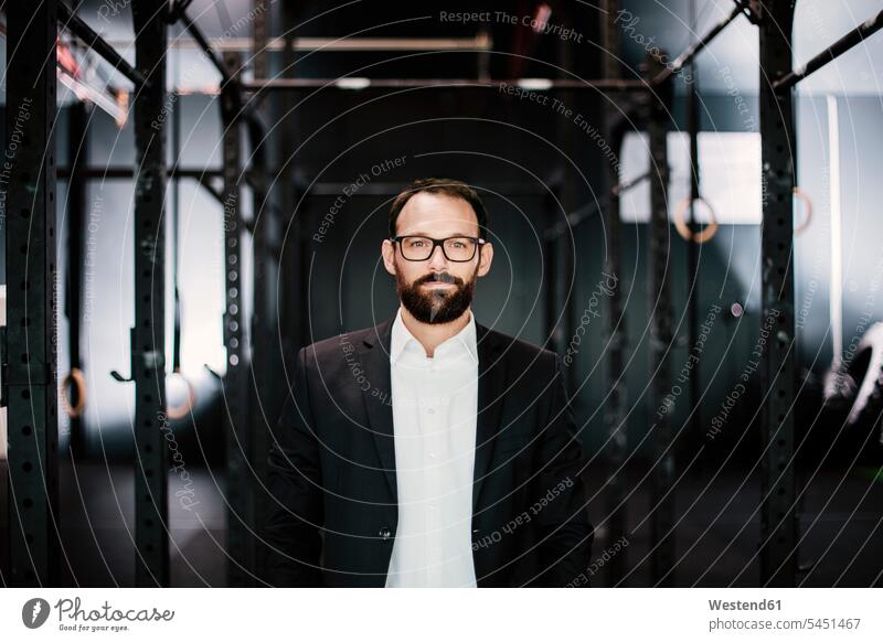 Portrait of an ambitious businessman, standing in fitness studio confidence confident portrait portraits beard glasses specs Eye Glasses spectacles Eyeglasses