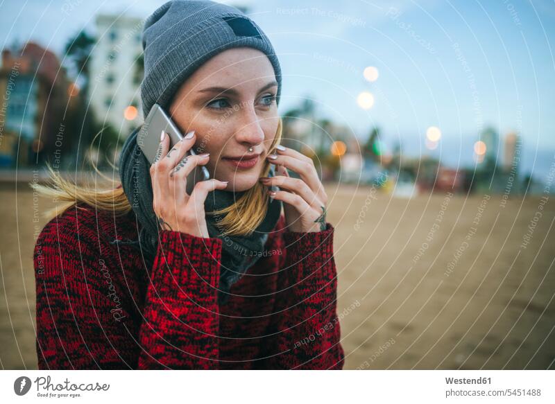 Young woman on the beach in winter on cell phone on the phone call telephoning On The Telephone calling beaches females women telephone call Phone Call