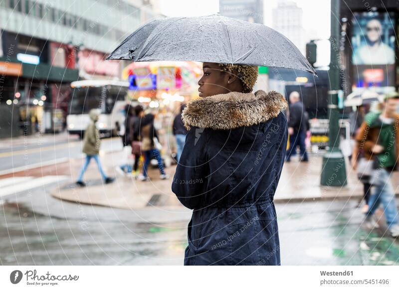 USA, New York City, young woman with umbrella on rainy day copy space females women umbrellas Adults grown-ups grownups adult people persons human being humans
