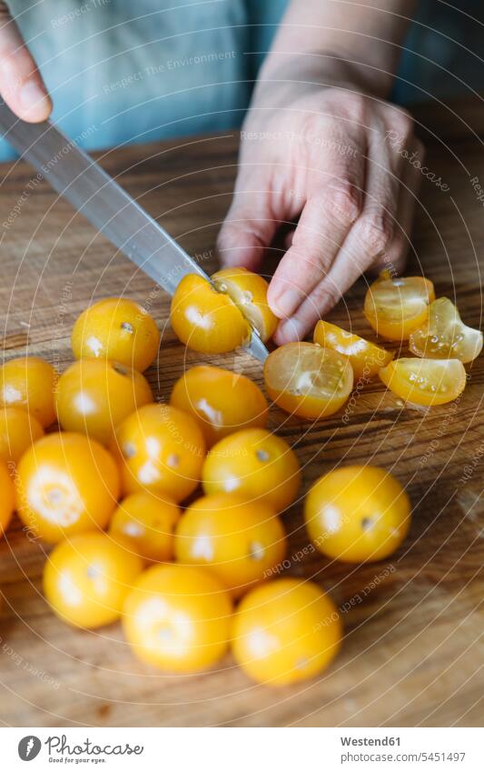 Close-up of woman cutting fresh tomatoes Tomato Tomatoes females women cooking Vegetable Vegetables Food foods food and drink Nutrition Alimentation