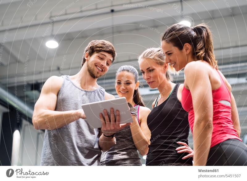 Group of happy athletes with tablet after exercising in gym gyms Health Club digitizer Tablet Computer Tablet PC Tablet Computers iPad Digital Tablet
