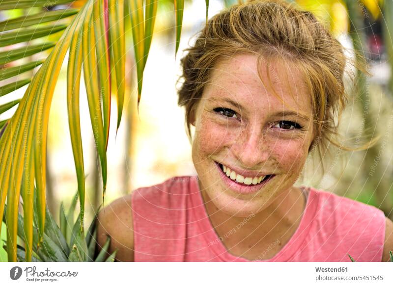 Dominican Republic, portrait of laughing strawberry blonde young woman with freckles portraits females women Adults grown-ups grownups adult people persons