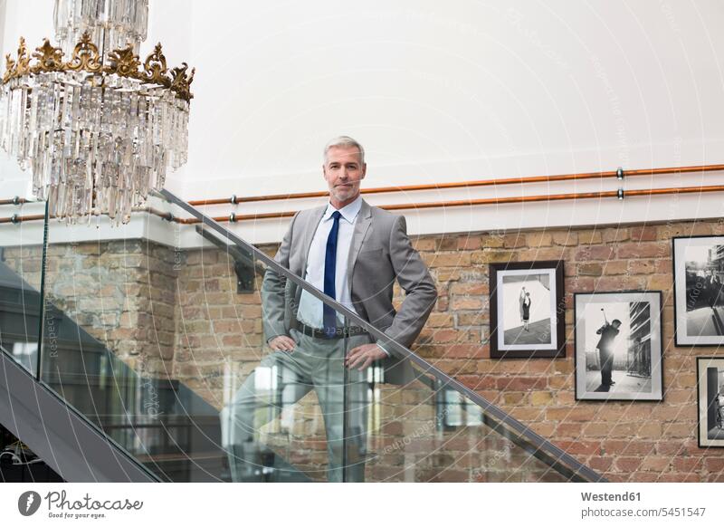 Mature businessman in modern office standing on stairs caucasian caucasian ethnicity caucasian appearance european convenience amenities convenient amenity