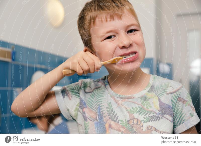 Portrait of boy brushing his teeth in bathroom of a kindergarten portrait portraits brushing teeth boys males nursery school toothbrush tooth-brushes