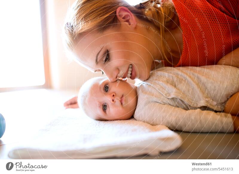 Happy mother with baby at home smiling smile mommy mothers ma mummy mama happiness happy infants nurselings babies parents family families people persons