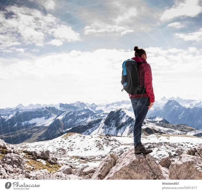 Germany, Bavaria, Oberstdorf, woman standing on rock in alpine scenery females women mountain range mountains mountain ranges hiking hike rocks Adults grown-ups