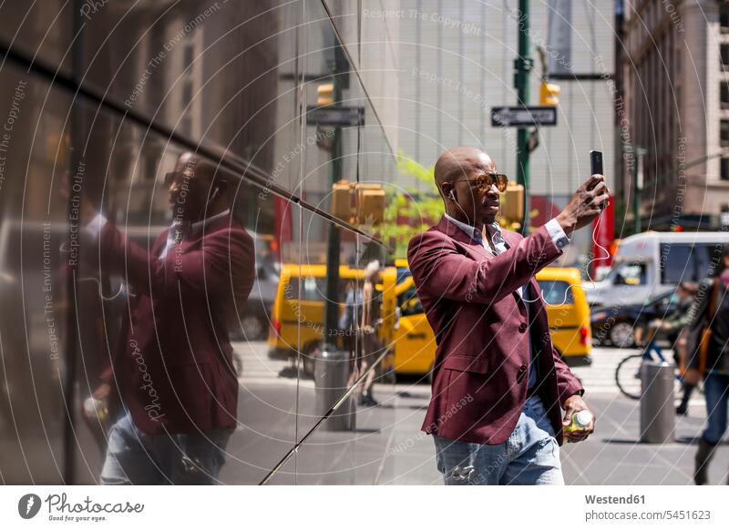 USA, New York City, Manhattan, stylish businessman taking selfie with smartphone Selfie Selfies Businessman Business man Businessmen Business men