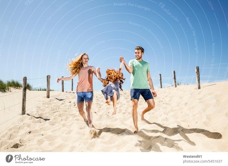 Netherlands, Zandvoort, happy family with daughter on the beach families beaches Fun having fun funny happiness people persons human being humans human beings