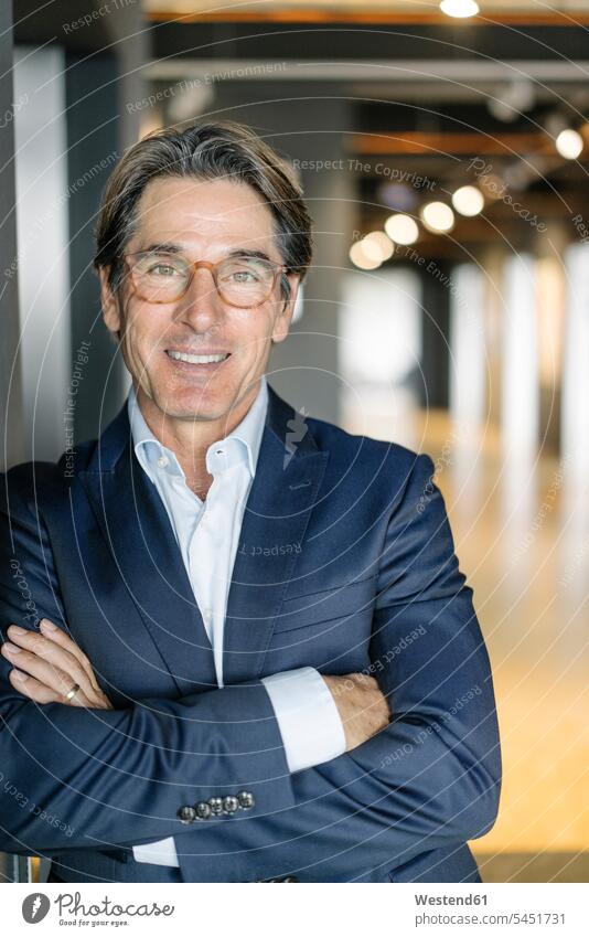 Portrait of smiling businessman wearing glasses in office specs Eye Glasses spectacles Eyeglasses portrait portraits Businessman Business man Businessmen
