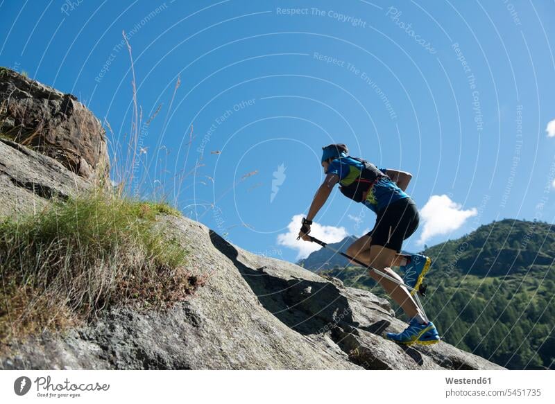 Italy, Alagna, trail runner on the move near Monte Rosa mountain massif running mountains athlete Sportspeople Sportsman Sportsperson athletes Sportsmen males