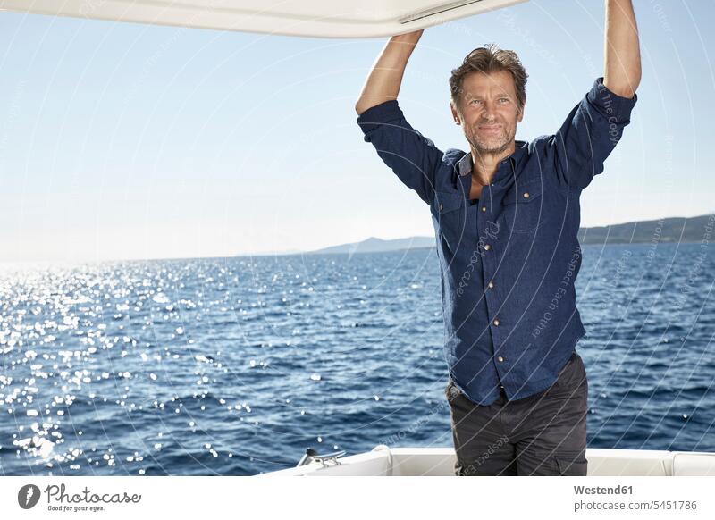 Portrait of mature man on motor yacht men males motor yachts portrait portraits Adults grown-ups grownups adult people persons human being humans human beings
