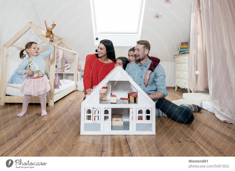 Happy family with three daughters in nursery playing Fun having fun funny children's room Kids Room child's room families people persons human being humans