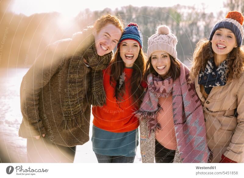 Portrait of happy friends outdoors in winter laughing Laughter happiness positive Emotion Feeling Feelings Sentiments Emotions emotional friendship portrait
