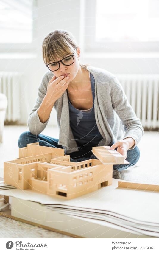 Woman in office looking at architectural model Office Offices woman females women Architecture eyeing models Adults grown-ups grownups adult people persons